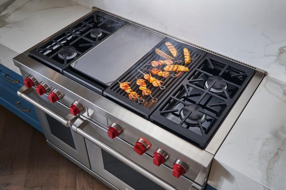 A Wolf range with a stove-top grill and griddle.