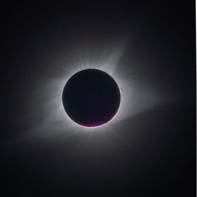 The eclipse as viewed from Bald Mountain, Idaho, photographed by Kevin Lisota. The purple coloring on the underside is an eclipse phenomenon known as Baily’s Beads, in which the craters on the moon’s surface allow partial sunlight to shine through. (GeekWire Photo / Kevin Lisota)