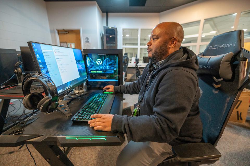 Andrew Nunn, esports coordinator at Pueblo Community College, configures one of the college's high-end gaming computers that will eventually be used in the AI curriculum.