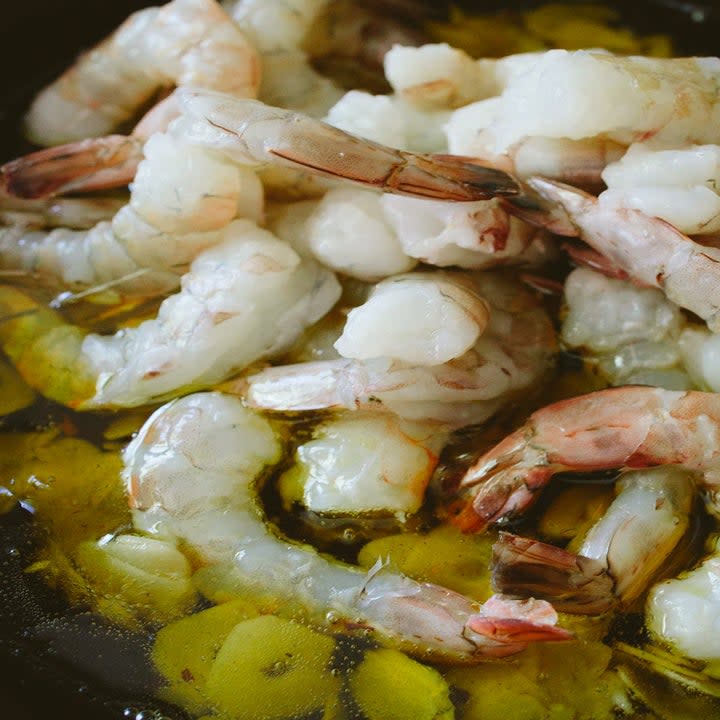 Uncooked shrimp in garlic and oil.