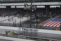 Colton Herta takes the checkered flag to win the IndyCar Grand Prix auto race at Indianapolis Motor Speedway, Saturday, May 14, 2022, in Indianapolis. (AP Photo/Darron Cummings)