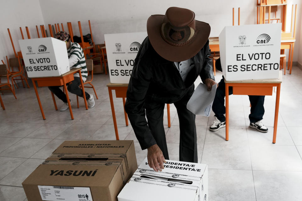 A man votes in a presidential election in Cayambe, Ecuador, Sunday, Aug. 20, 2023. The special election was called after President Guillermo Lasso dissolved the National Assembly by decree in May to avoid being impeached. (AP Photo/Dolores Ochoa)