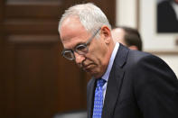 Former FirstEnergy Senior Vice President Michael Dowling prepares to sit down inside the courtroom at the Summit County courthouse in Akron, Ohio on Tuesday, Feb. 13, 2024. Two fired executives of FirstEnergy Corp. and a former top state utilities regulator pleaded not guilty Tuesday to state charges related to a $60 million bribery scheme that centered on securing a legislative bailout for two Ohio nuclear power plants with the help of a powerful House speaker. (AP Photo/David Dermer)