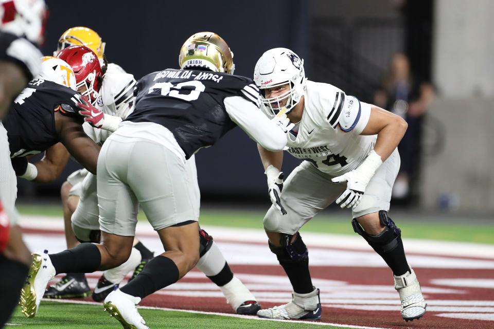 East offensive tackle Ryan Van Demark, of UConn, (74) in coverage against West defensive lineman Myron Tagovailoa-Amosa, of Notre Dame, (99) during the East West Shrine Bowl football game at Allegiant Stadium in Las Vegas, Thursday, Feb. 3, 2022. (AP Photo/Gregory Payan)