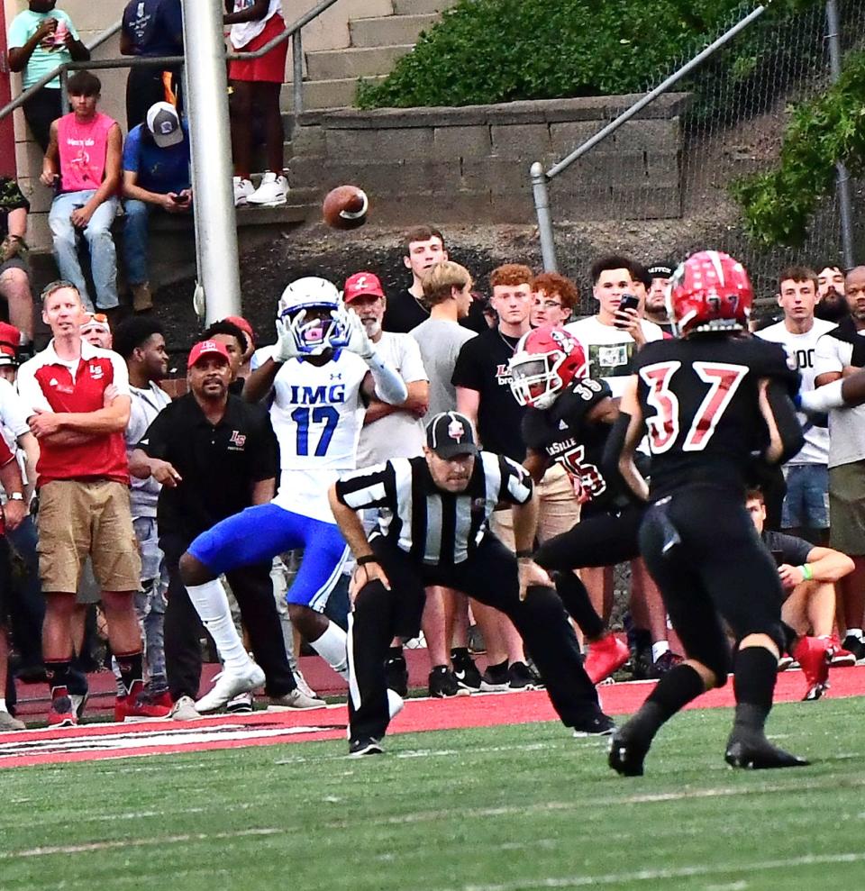 IMG Academy's Carnell Tate (17) eyes a touchdown catch for the Ascenders at Lancers Stadium, Sept. 3, 2021.