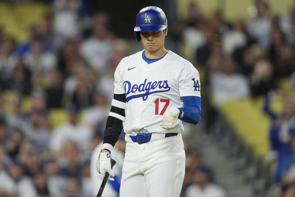 Los Angeles Dodgers designated hitter Shohei Ohtani reacts after fouling off a pitch during the eighth inning of the team's baseball game against the Texas Rangers, Thursday, June 13, 2024, in Los Angeles. (AP Photo/Ryan Sun)