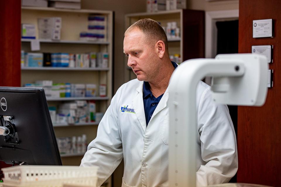 Pharmacist Ashley Buckman fills prescriptions during a busy afternoon at B & B Pharmacy in Shepherdsville. Customers are finding that COVID-19 test kits are hard to come by with some stores out of stock following a surge in purchases from  people anxious to check for COVID-19 before holiday gatherings.