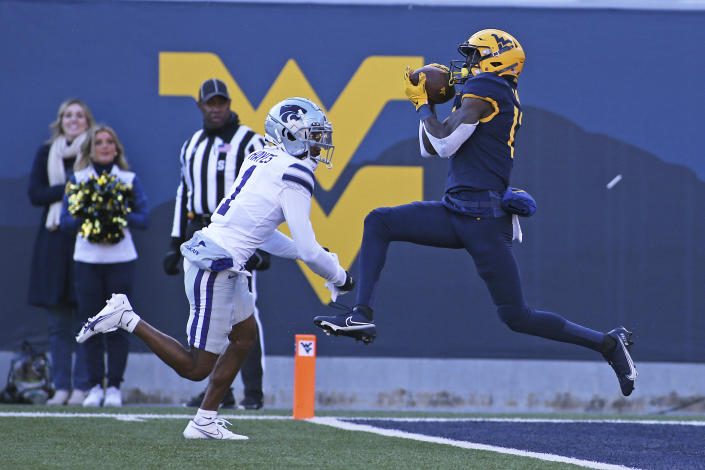 West Virginia wide receiver Sam James catches a touchdown pass while defended by Kansas State safety Josh Hayes during the first half of an NCAA college football game in Morgantown, W.Va., Saturday, Nov. 19, 2022. (AP Photo/Kathleen Batten)
