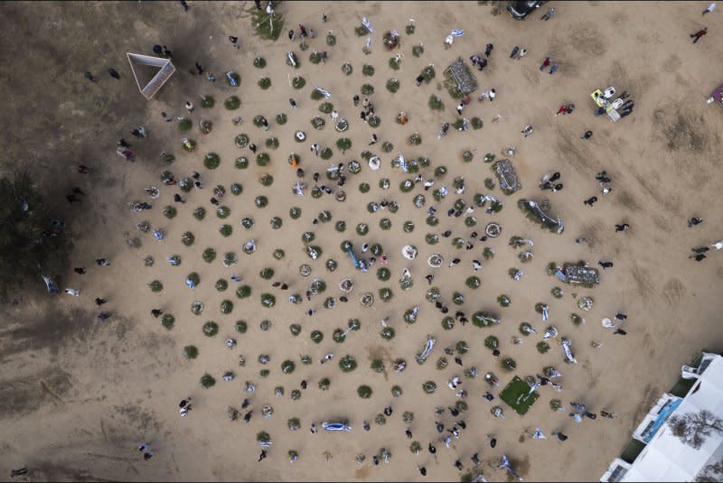 An aerial view of the memorial to the Israelis killed in the Nova dance party in Re'im, southern Israel, near the border with the Gaza Strip. The memorial, seen Tuesday, displays photographs, flowers and personal items of the 325 Israeli slaughtered by Hamas terrorists on October 7, 2023, along with those taken hostage. It is a popular area to visit for both Israelis and foreign visitors. Photo by Jim Hollander/UPI
