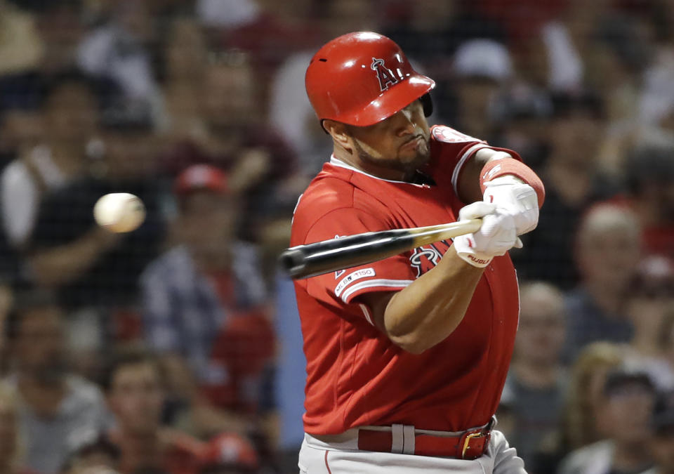 Los Angeles Angels' Albert Pujols swings and misses at a pitch from Boston Red Sox starting pitcher Chris Sale during the seventh inning of a baseball game at Fenway Park, Thursday, Aug. 8, 2019, in Boston. (AP Photo/Elise Amendola)