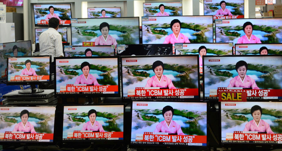 <p>TV screens at a Yongsan Electronic shop show a North Korean newscaster reading a public announcement at in Seoul, South Korea, Tuesday, July 4, 2017. (Photo: Lim Tae-hoon/Newsis via AP) </p>