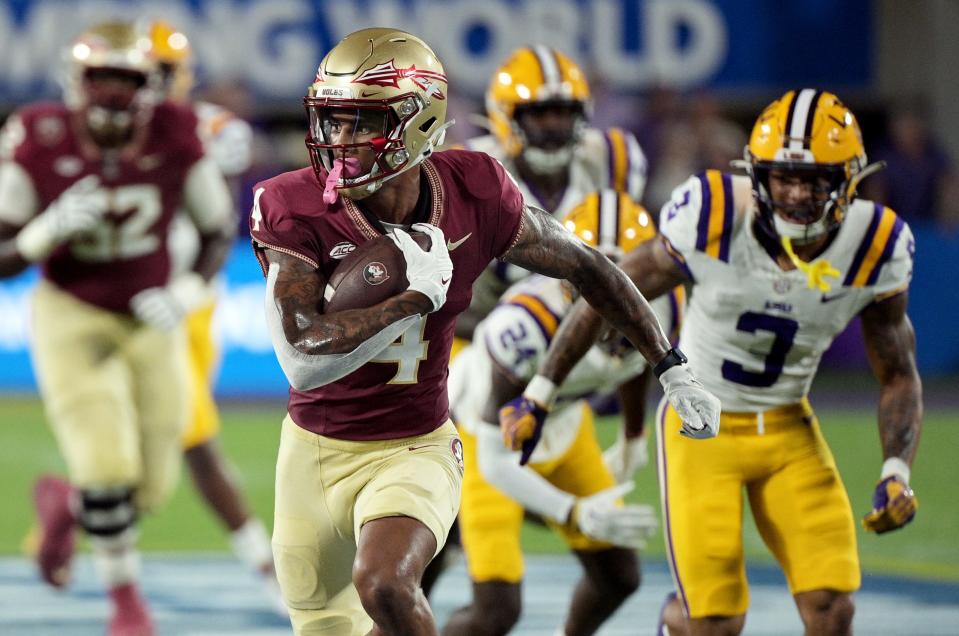 Florida State Seminoles wide receiver Keon Coleman runs for a touchdown during the first half against the Louisiana State Tigers at Camping World Stadium, Sept. 3, 2023 in Orlando.