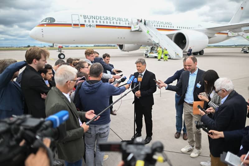 German Minister of Economic Affairs and Climate Protection Robert Habeck makes a statement at the military section of Berlin Brandenburg Airport ahead of his trip to South Korea and China.  Sebastian Christoph Gollnow/dpa
