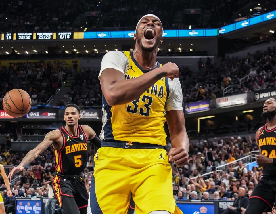 Indiana Pacers center Myles Turner (33) celebrates a big dunk during a game between the Indiana Paces and the Atlanta Hawks on Sunday, April 14, 2024, at Grainbridge Fieldhouse in Indianapolis. Atlanta Hawks guard Dejounte Murray (5) and Atlanta Hawks forward Bruno Fernando (24).