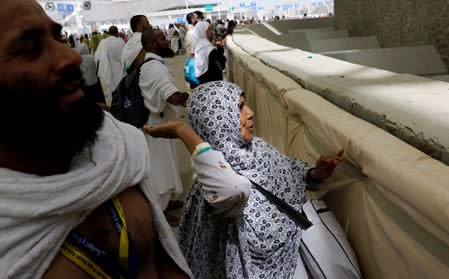 Muslim pilgrims cast their stones at a pillar symbolising the stoning of Satan during the annual haj pilgrimage in Mina