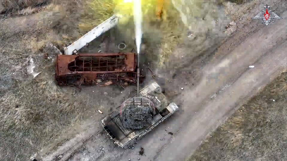 In this photo taken from video and released by the Russian Defense Ministry Press Service on Monday, April 8, 2024, a Russian tank fires towards an Ukrainian position in an undisclosed location in Ukraine. (Russian Defense Ministry Press Service via AP)