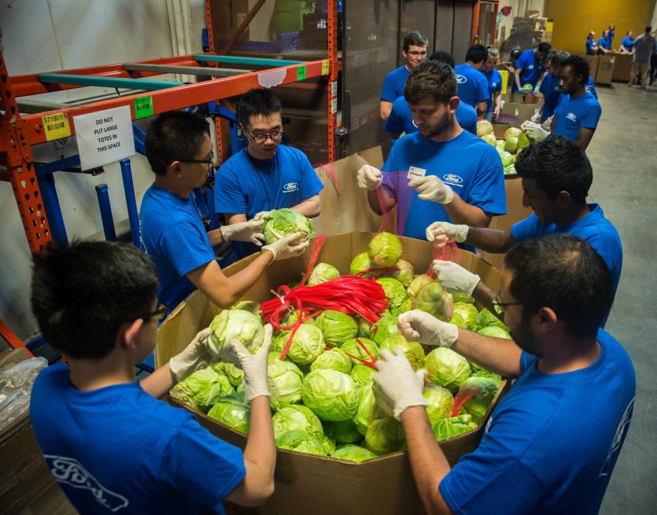 Volunteers bag cabbage at Gleaners Food Bank in Detroit on July 3, 2018.