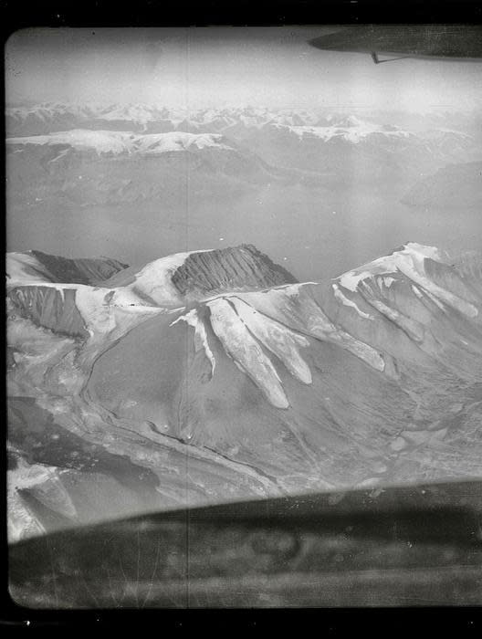black and white, very aged aerial photo of a Greenland mountain glacier.