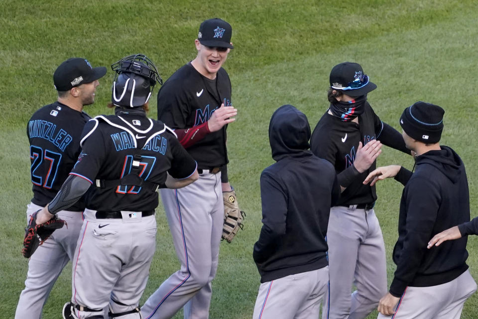 Members of the Miami Marlins celebrate after defeating the Chicago Cubs in Game 2 of a National League wild-card baseball series Friday, Oct. 2, 2020, in Chicago. The Marlins won the series 2-0 to advance to the division series. (AP Photo/Nam Y. Huh)