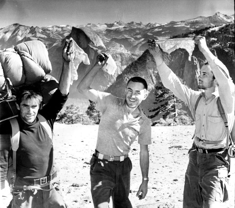 From left, Warren Harding, Wayne Merry and George Whitmore wave their handkerchiefs in elation at scaling the unclimbed face of El Capitan in Yosemite National Park in 1958. The picture was taken by Fresno Bee staff photographer Loyal Savaria within a few minutes after they walked up to the summit. Whitmore, a member of the first team of climbers to scale El Capitan in Yosemite National Park and a conservationist who devoted his life to protecting the Sierra Nevada, has died. He was 89. Whitmore died on New Year's Day from complications caused by COVID-19, said his wife, Nancy. (Loyal Savaria/Fresno Bee Archive via AP)
