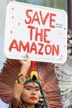 People demonstrate during an Extinction Rebellion protest outside the Brazilian embassy in London