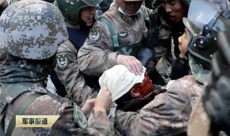 In this image taken from video footage run Feb. 19, 2021 by China's CCTV via AP Video, soldiers bandage the head of China's People's Liberation Army (PLA) regimental commander Qi Fabao as Indian and Chinese troops face off in the Galwan Valley on the disputed border between China and India, June 15, 2020. China's military said Friday, Feb. 19, 2021 that four of its soldiers were killed in a high-mountain border clash with Indian forces last year, the first time Beijing has publicly conceded its side suffered casualties in the deadliest incident between the Asian giants in nearly 45 years. (CCTV via AP Video)