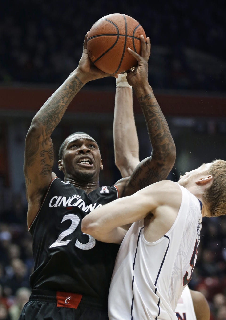FILE - In this Feb. 6, 2014 file photo, Cincinnati guard Sean Kilpatrick (23) shoots against Connecticut guard Niels Giffey during the first half of an NCAA college basketball game in Cincinnati. Kilpatrick was selected to The Associated Press All-America team, released Monday, March 31, 2014. (AP Photo/Al Behrman, File)