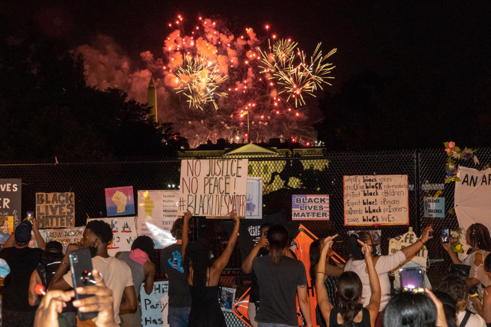 <strong>Washington, Aug., 27, 2020.</strong> "A modest number of protesters gathered outside the fence sealing off the White House from Black Lives Matter Plaza. As Trump's speech accepting the Presidential nomination ended, a massive display of fireworks filled the air. Some protesters pressed against the fence to shout obscenities and wave their middle finger towards the White House. It feels as if the tension is only going to ramp up as the election quickly approaches."<span class="copyright">Peter van Agtmael—Magnum Photos for TIME</span>