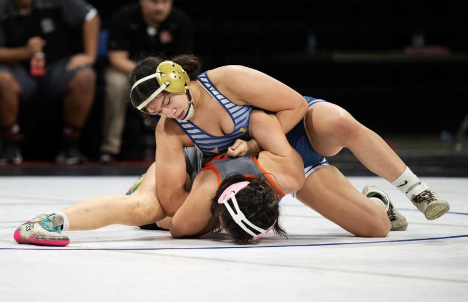 Dulcy Martinez of Central Catholic ties up Merced’s Aliza Sanchez in the Sac-Joaquin Section Masters Wrestling Championships at Stockton Arena in Stockton, Calif., Saturday, Feb. 17, 2024. Martinez won by fall at 3:52.