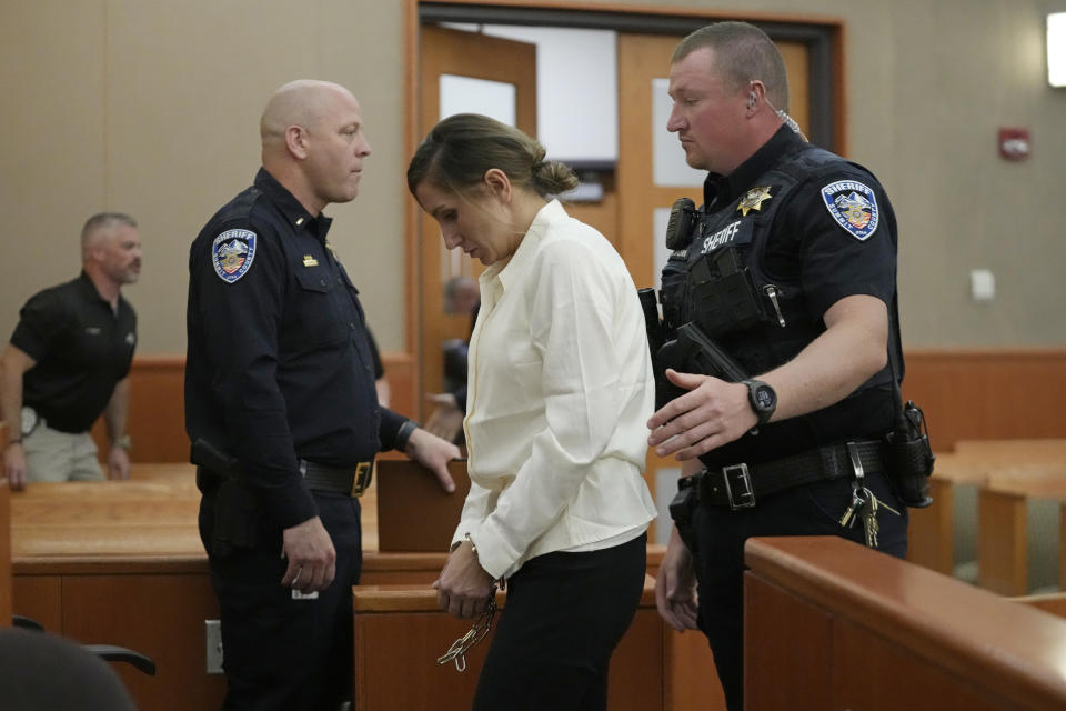 Kouri Richins, a Utah mother of three who authorities say fatally poisoned her husband then wrote a children's book about grieving, walks out of the court during a recess at a bail hearing Monday, June 12, 2023, in Park City, Utah. A judge ruled to keep her in custody for the duration of her trial. (AP Photo/Rick Bowmer, Pool)