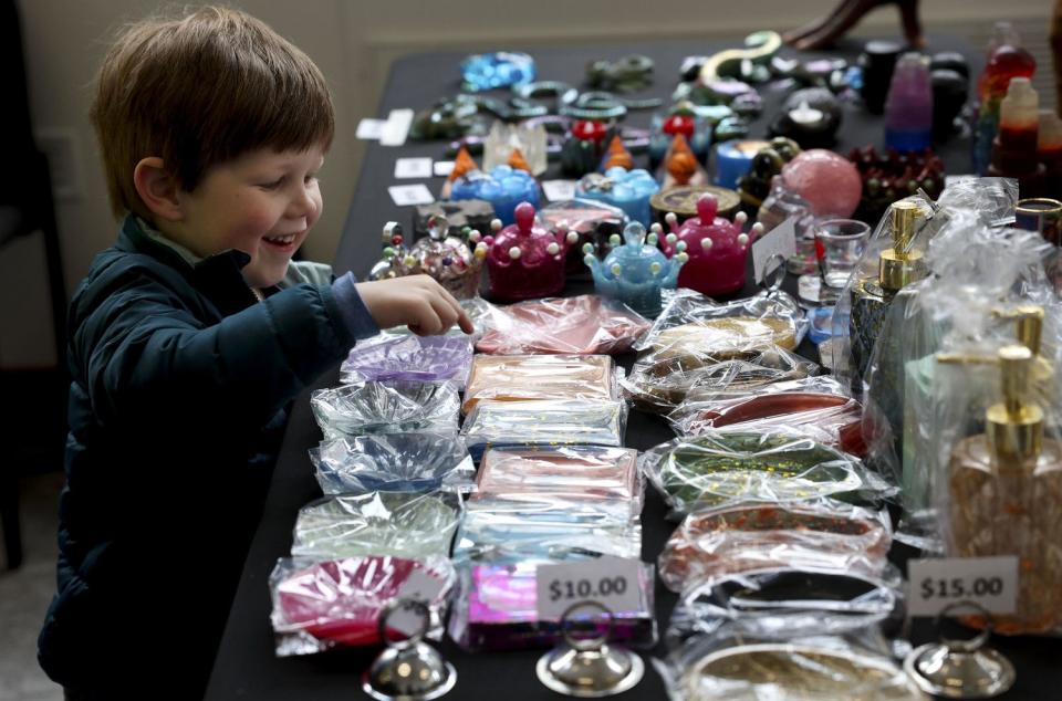 Roen Brewster shops at Ebi Monkurai’s table at the Utah Black Chamber's "Black and Open for Business" at the Zions Bank Eagle Emporium on Main Street in Salt Lake City on Friday. The marketplace runs Fridays and Saturdays from 10 a.m. to 6 p.m. through Saturday, April 8.