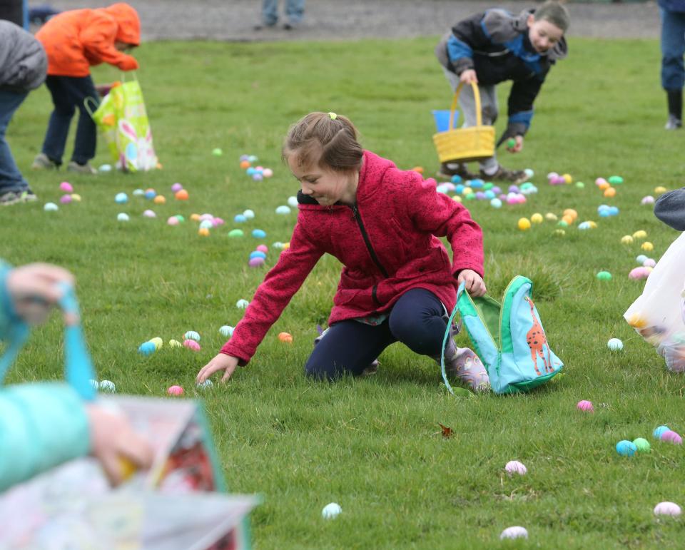 Adeline Murray collects eggs Saturday during the North Canton Jaycees' annual Easter Egg Hunt in North Canton.