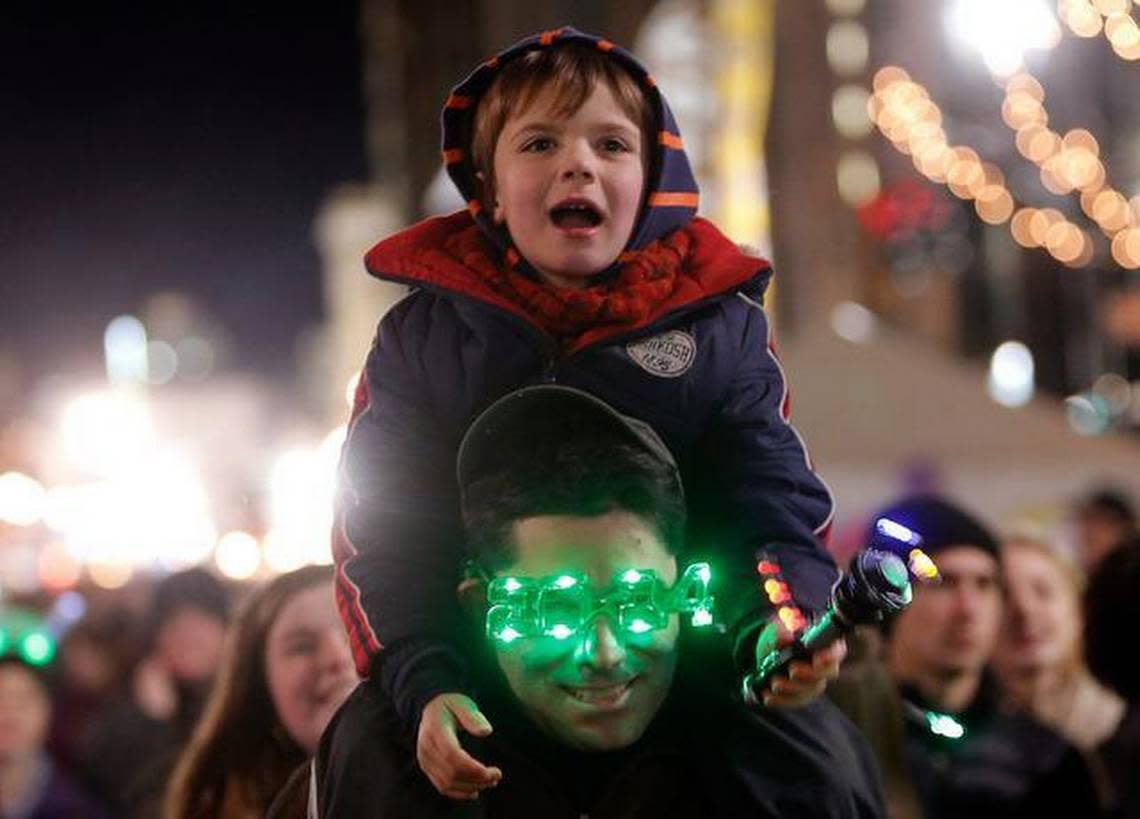 David LeBouef and his son Max LeBouef, 5, of Raleigh prepare to watch the 7 p.m. acorn drop during the 2014 First Night Raleigh celebration on Tuesday.