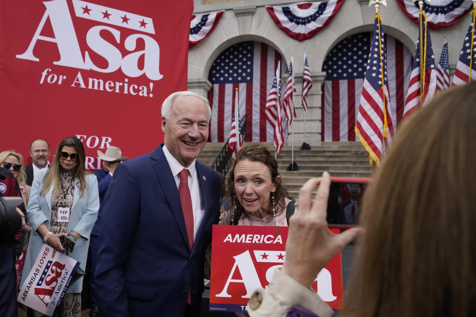 Former Arkansas Gov. Asa Hutchinson poses for a photo with supporter Leigh Fox, of Bella Vista, Ark., after formally announcing his Republican campaign for president, Wednesday, April 26, 2023, in Bentonville, Ark. (AP Photo/Sue Ogrocki)