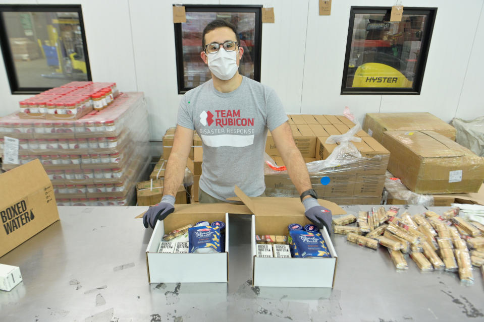 BRONX, NEW YORK - JANUARY 14: Volunteers help pack boxes as Barilla Honors MLK Day Providing Meals To New Yorkers In Need With Food Bank For New York City on January 14, 2021 in Bronx, New York. (Photo by Michael Loccisano/Getty Images for Food Bank For New York City)