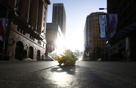 A bouquet is pictured inside a secured area at the scene of a hostage taking at Martin Place after it ended in Sydney early December 16, 2014. REUTERS/Jason Reed
