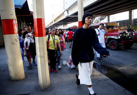 Oliver Emocling, 23, who works for a magazine, walks to the train station in Caloocan City, Philippines, October 15, 2018. On weekdays, especially at rush hour, it takes him almost two hours to get to work. "I've accepted that this is the reality of having to work in Makati, and live in Malabon. This is how it is, no matter what I do, no matter what means of transportation I take." REUTERS/Eloisa Lopez