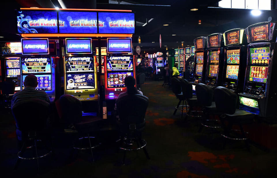 Customers sit at poker machines in the gaming room at the Vikings Club in Canberra, Australia, on Monday, Sept. 26, 2016. (Photographer: Mark Graham/Bloomberg via Getty)