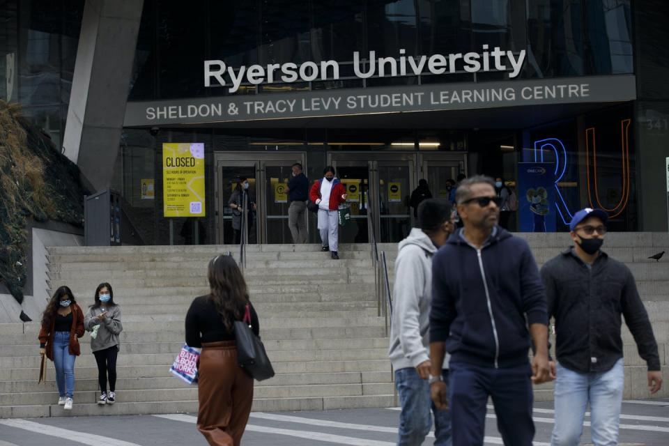 People walk in front of a Ryerson University building.