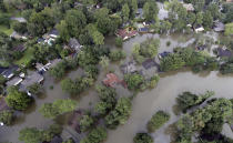 <p>Homes are surrounded by floodwaters from Tropical Storm Harvey Tuesday, Aug. 29, 2017, in Spring, Texas. (Photo: David J. Phillip/AP) </p>