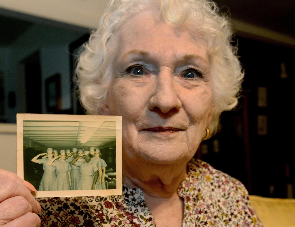 Rita Rey of Springfield holds up a photo of her platoon at her home recently. Rey served in the U.S. Women's Army Corps from 1969 to 1972 and will be one of two women veterans as part of Tuesday's Land of Lincoln Honor Flight. It is the first Honor Flight to operate from Springfield since October 2019 because of the COVID-19 pandemic.