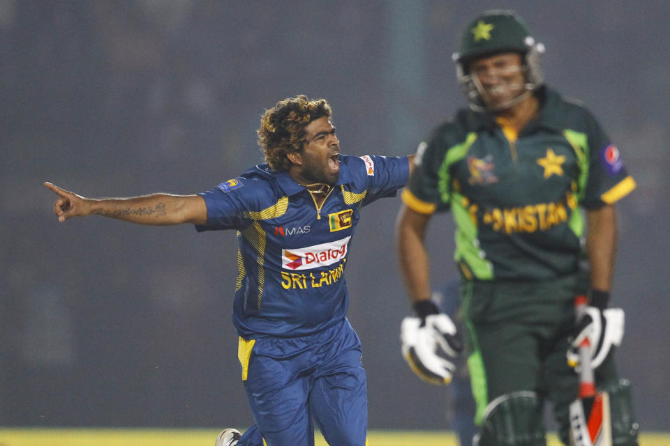 Sri Lanka’s Lasith Malinga, left, celebrates taking the wicket of Pakistan’s Bilawal Bhatti during the opening match of the Asia Cup one-day international cricket tournament in Fatullah, near Dhaka, Bangladesh, Tuesday Feb. 25, 2014. (AP Photo/A.M. Ahad)