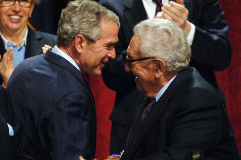 President George W. Bush greets former Secretary of State Henry Kissinger (r) after delivering prepared remarks on the economy before members of the Economic Club of New York at their luncheon at the Hilton Hotel in New York on March 14, 2008. Bush called Kissinger "one of the most dependable and distinctive voices on foreign affairs." File photo by Ezio Petersen/UPI