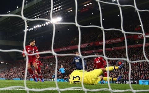 Jesse Lingard of Manchester United scores his team's first goal past Alisson of Liverpool - Credit: Getty