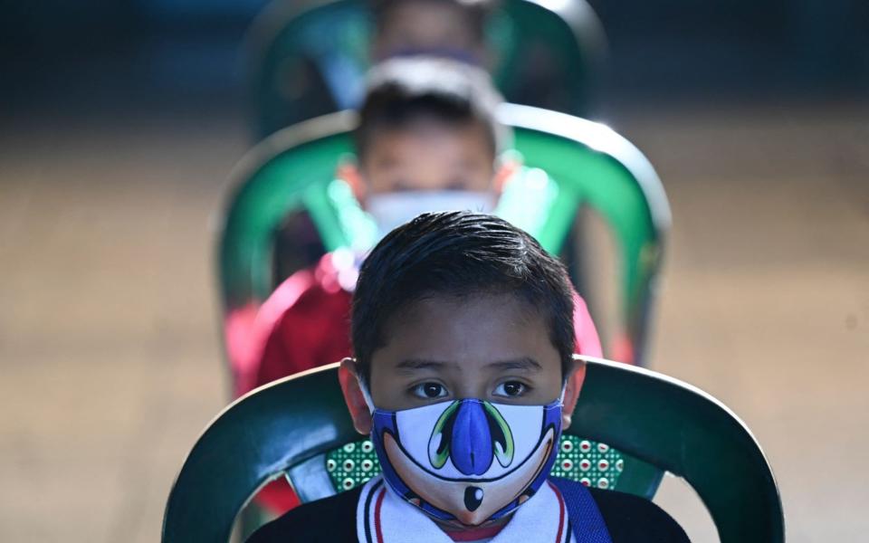 A child wearing a face mask at the Ramona Gil School in Chimaltenango, Guatemala - Johan Ordonez/AFP