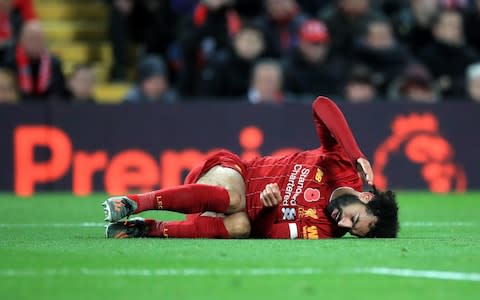 Mohamed Salah lying injured on the turf - Credit: PA