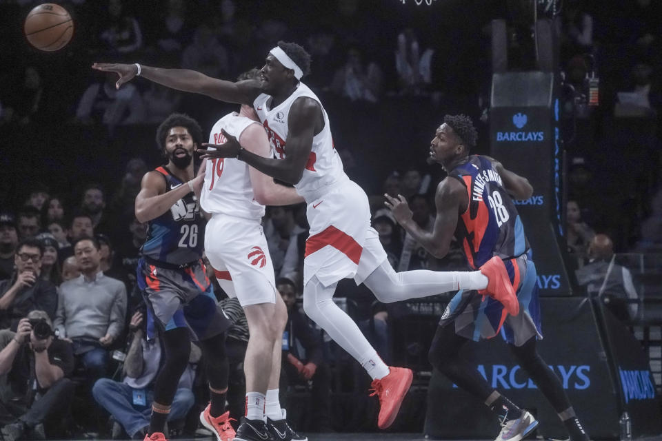 Toronto Raptors' Pascal Siakam, second from right, make a pass during the first half of an NBA In-Season Tournament basketball game against the Brooklyn Nets, Tuesday, Nov. 28, 2023, in New York. (AP Photo/Bebeto Matthews)