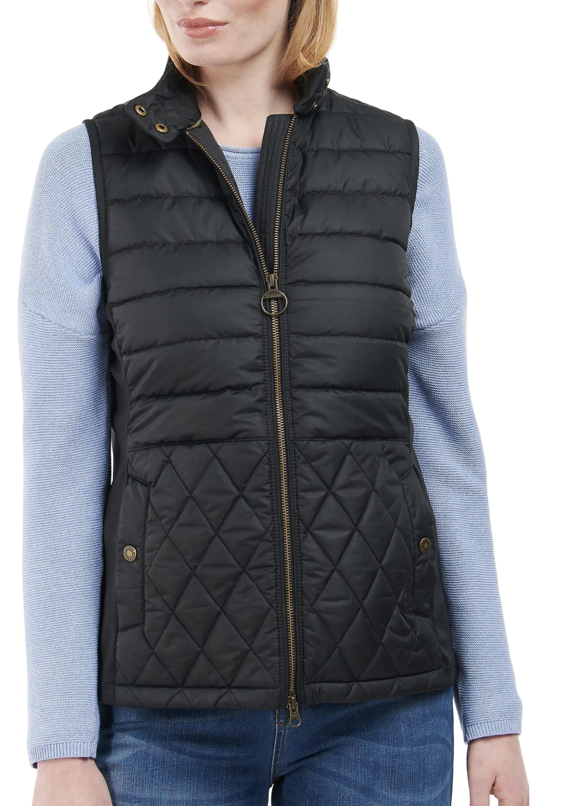 model wearing jeans, blue sweater and black Barbour Esme Quilted Vest (Photo via Nordstrom)