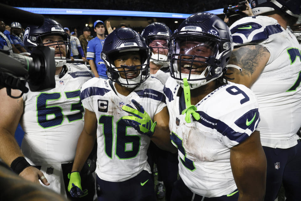 Seattle Seahawks wide receiver Tyler Lockett (16) celebrates with teammate running back Kenneth Walker III (9) after catching 6-yard touchdown pass during overtime in an NFL football game against the Detroit Lions, Sunday, Sept. 17, 2023, in Detroit. The Seahawks won 37-31. (AP Photo/Duane Burleson)