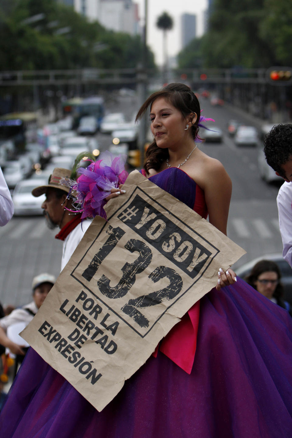 FILE - In this June 3, 2012 file photo, a 15-year-old girl holds up a sign that reads in Spanish " # I'm 132 for the freedom of expression" during a "Quinceanera" birthday celebration after a protest in Mexico City. Students challenged presidential candidates to debates, urged others their age to pay attention to the campaign, and sought to fight off the return of the Institutional Revolutionary Party, which held power for 71 years until its ouster in 2000. #132 is the name of a university movement that rejects the possible return of the Institutional Revolutionary Party. Mexico will hold presidential elections on July 1. (AP Photo/Marco Ugarte, File)